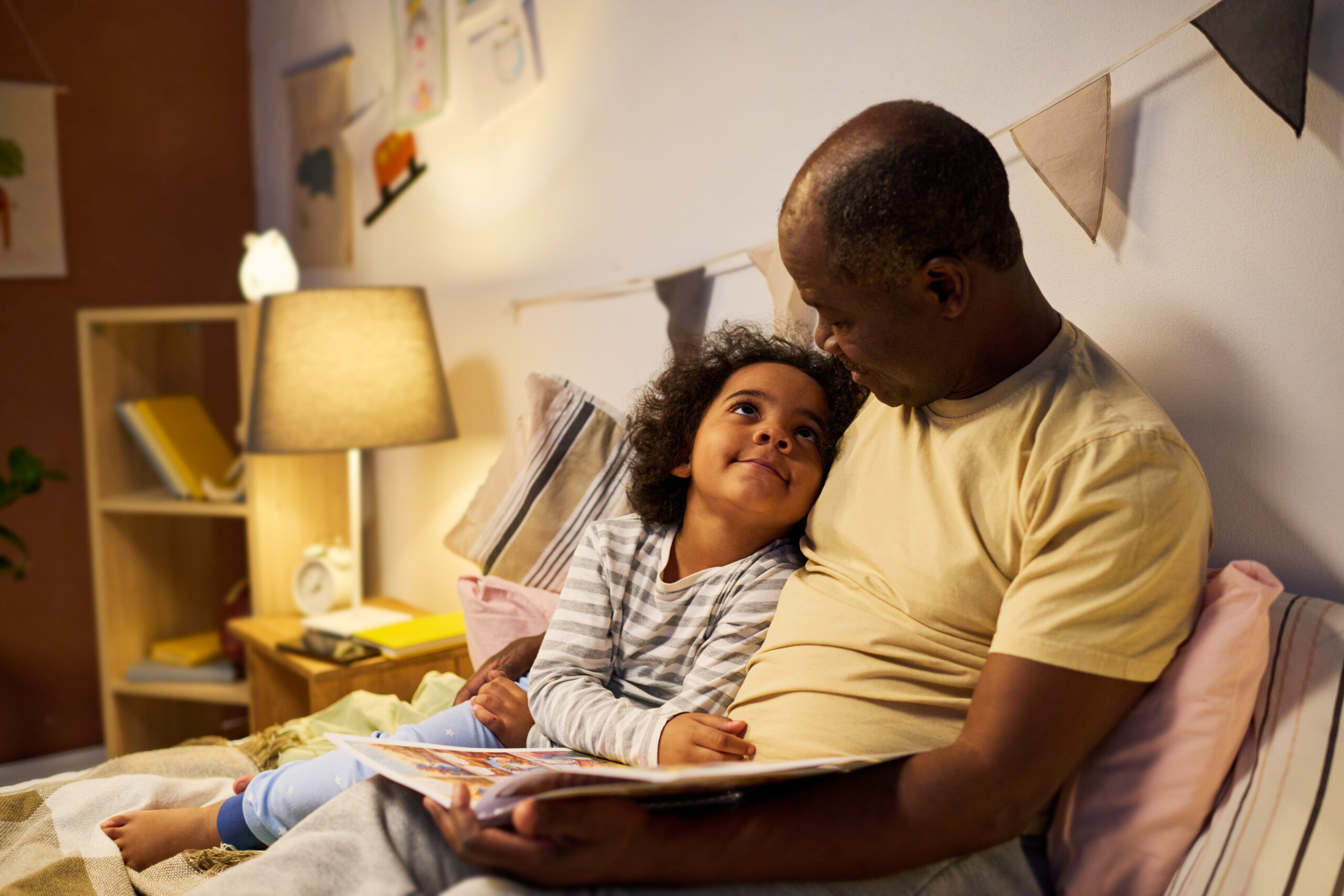 Dad reading book to child before sleep
